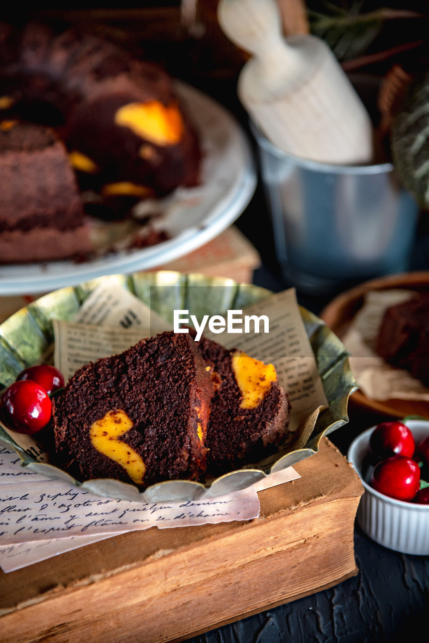 Close-up few slices of chocolate cake on a plate, served on a table