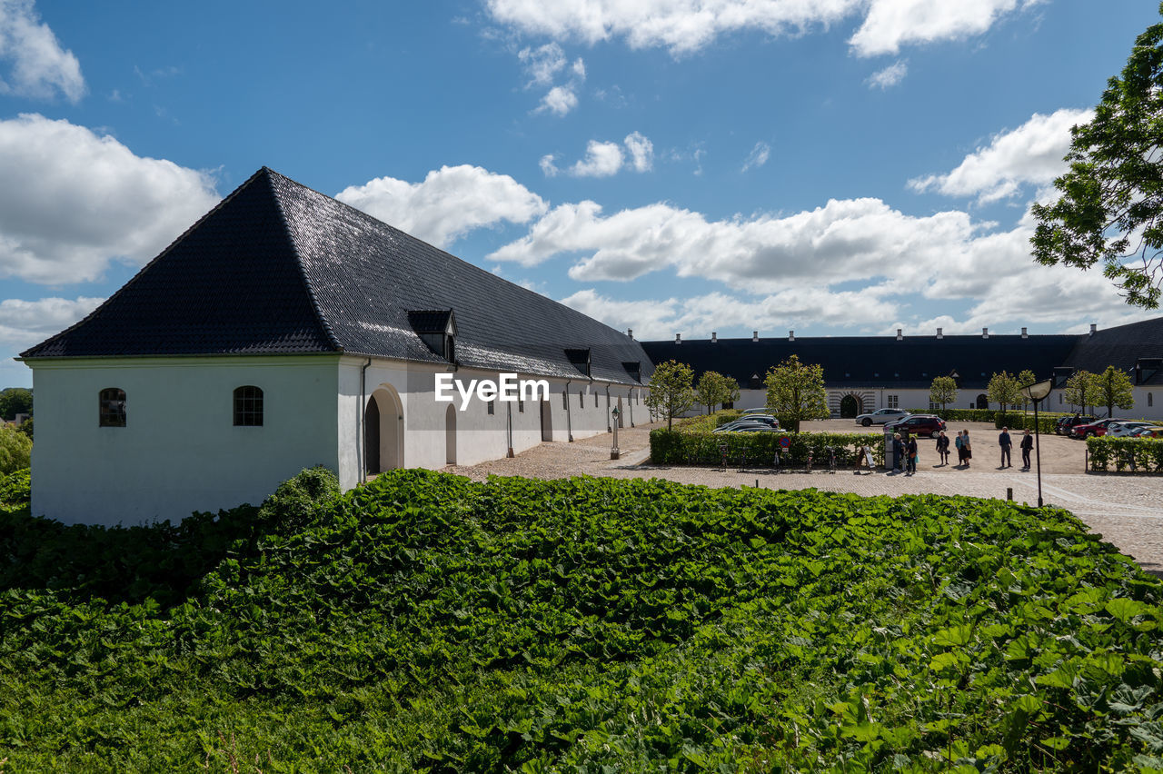 architecture, built structure, building exterior, building, house, plant, rural area, sky, nature, cloud, farm, residential district, estate, landscape, green, home, rural scene, no people, grass, land, mansion, outdoors, tree, day, environment, front or back yard, travel destinations, beauty in nature, agriculture