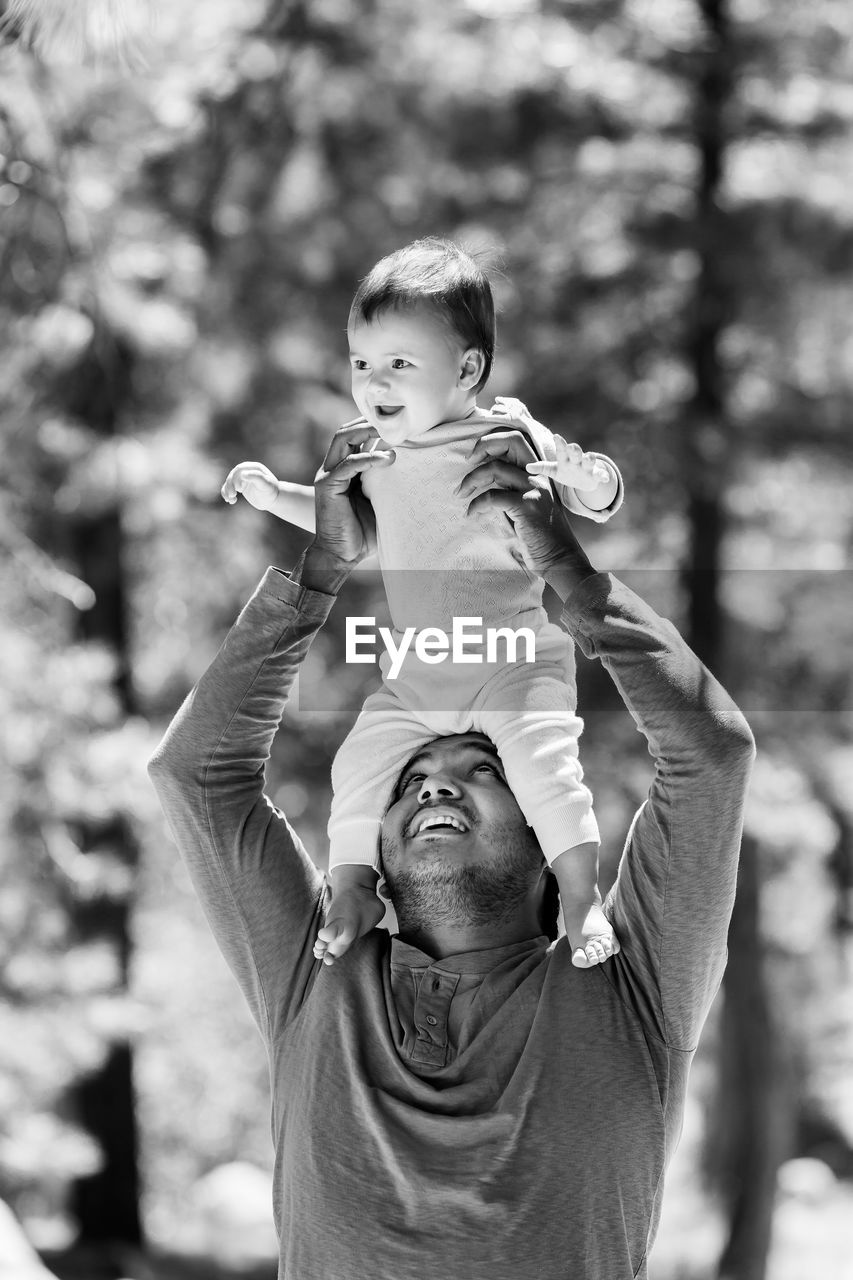 FATHER AND SON HOLDING BABY
