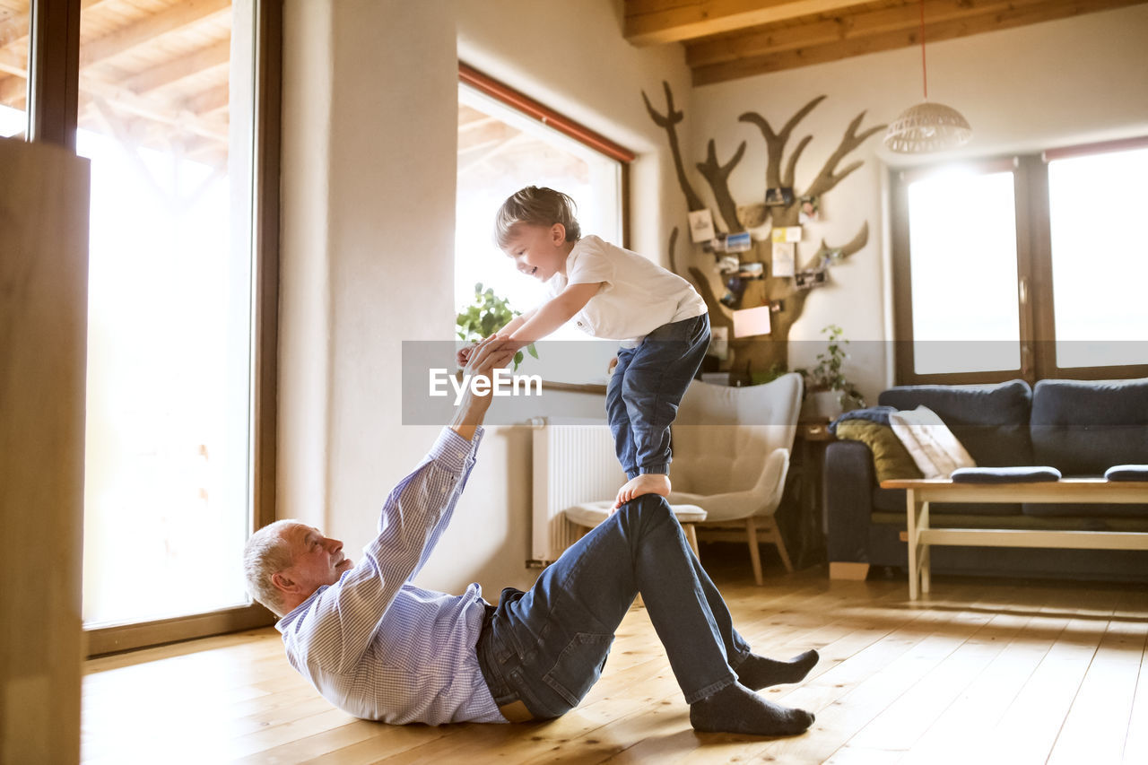 Grandfather and grandson having fun at home