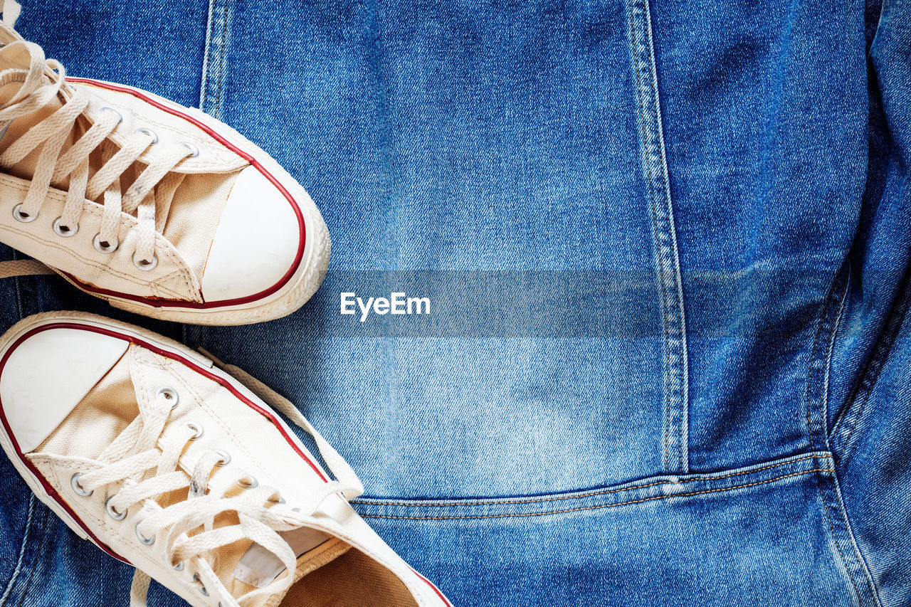 Close-up of shoes on denim shirt