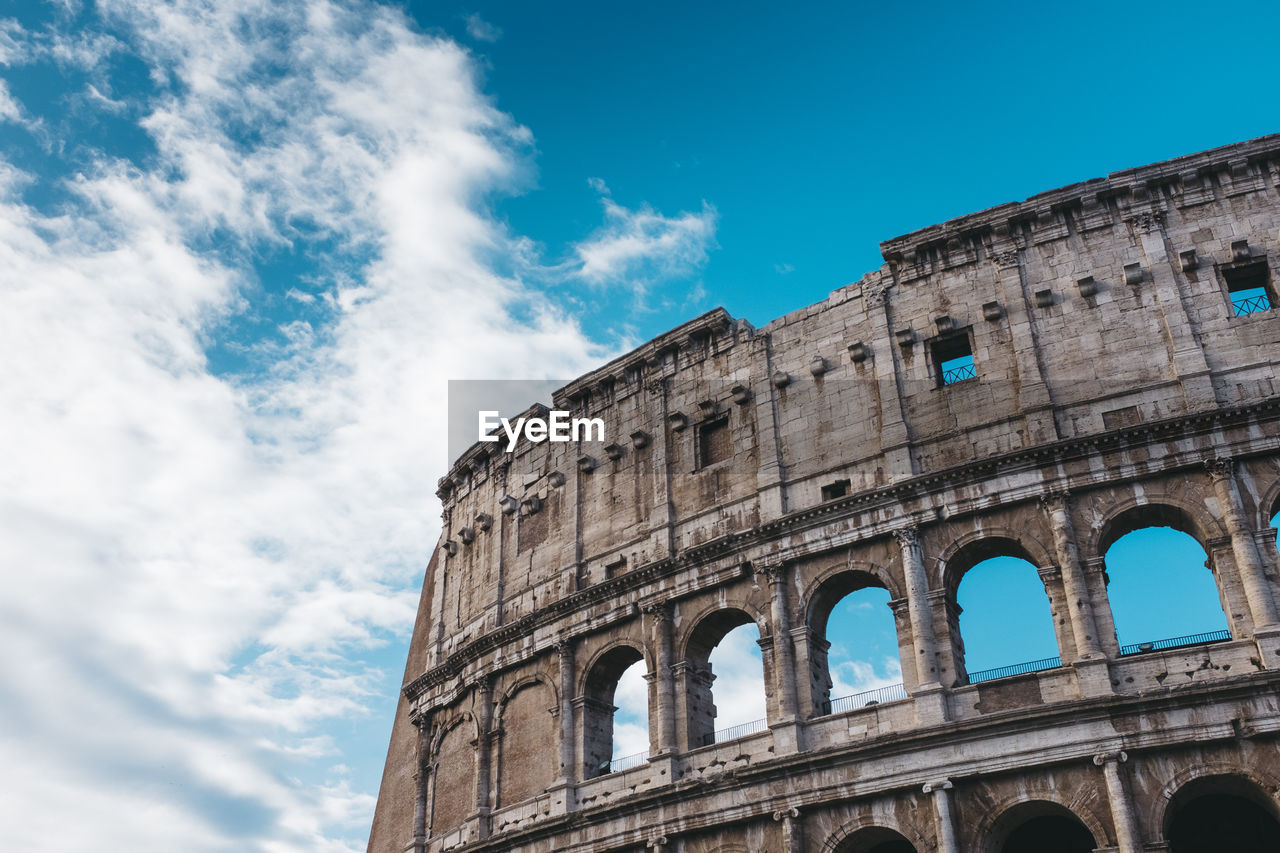 Low angle view of coliseum against sky