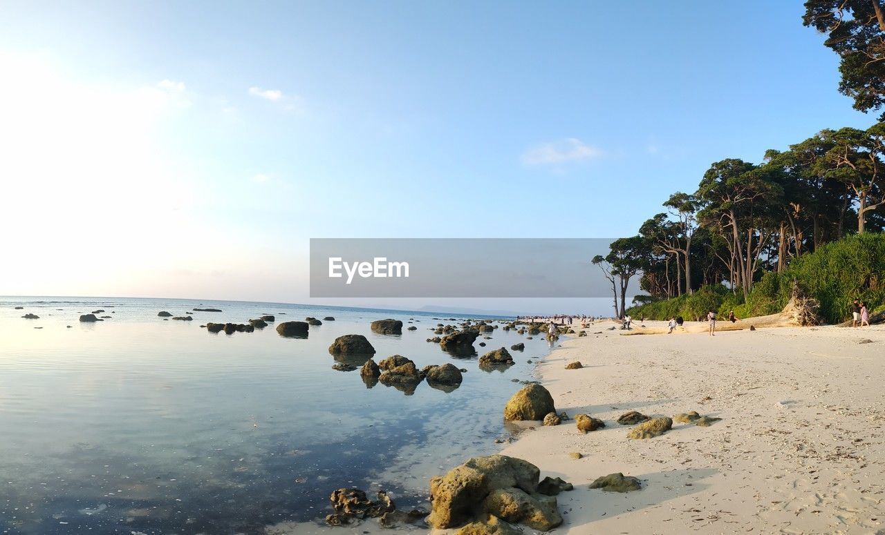water, sky, sea, body of water, beach, land, shore, nature, ocean, coast, beauty in nature, scenics - nature, tranquility, rock, cloud, tranquil scene, tree, sand, tropical climate, horizon over water, travel destinations, bay, plant, idyllic, vacation, no people, coastline, palm tree, environment, outdoors, travel, sunlight, day, horizon, blue, trip, holiday, wave, landscape, seascape, tourism, island, non-urban scene, reflection, summer
