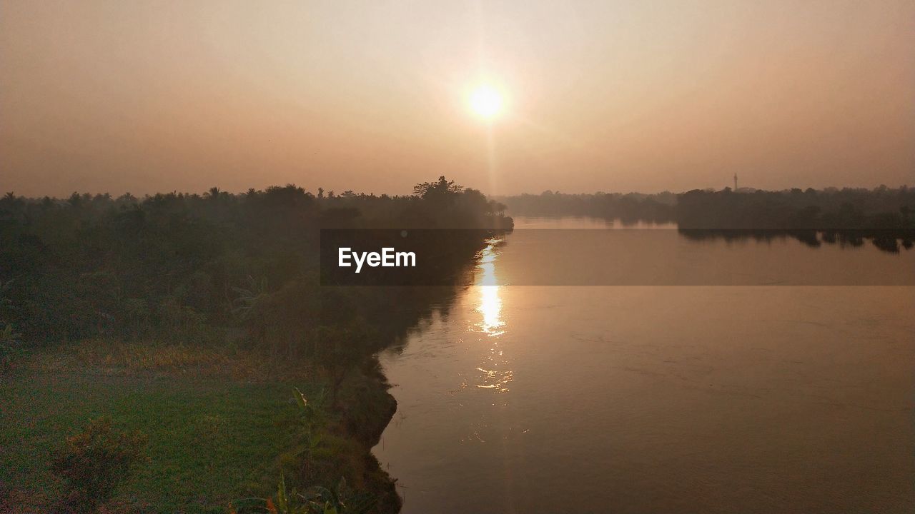 SCENIC VIEW OF LAKE DURING SUNSET