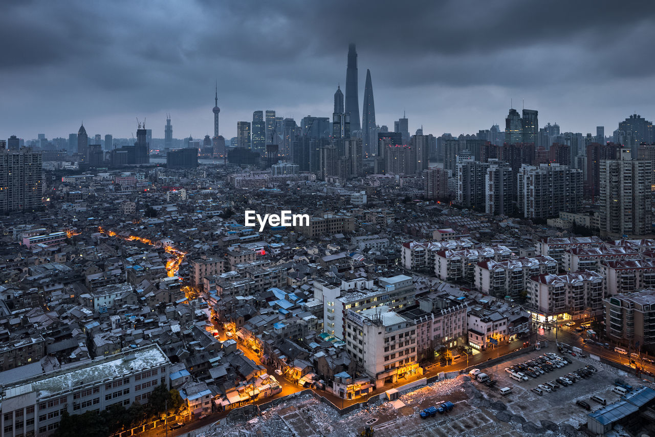 High angle view of illuminated cityscape against sky at dusk