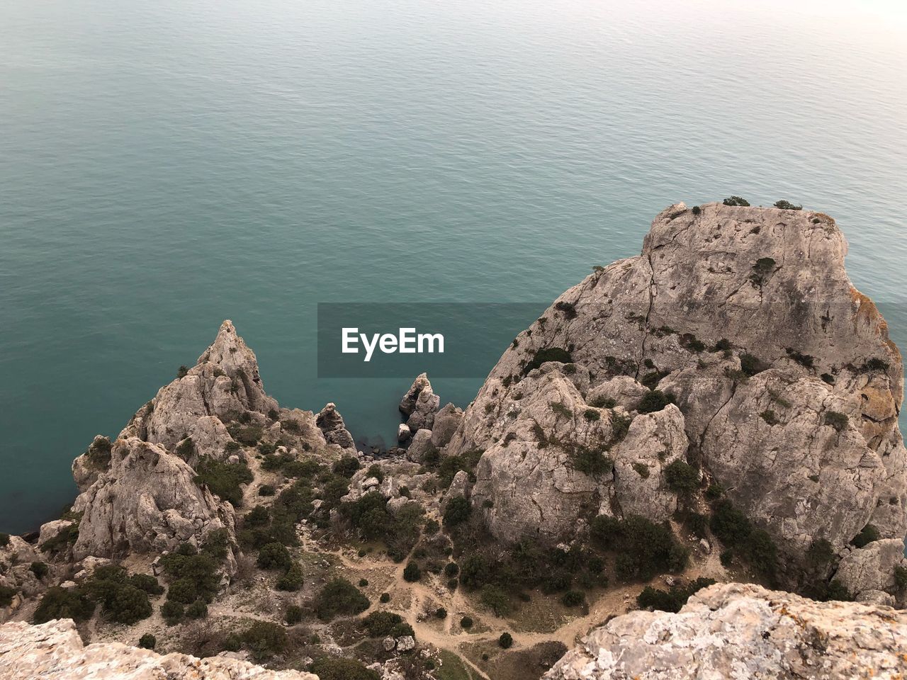 High angle view of rocks on sea shore against sky