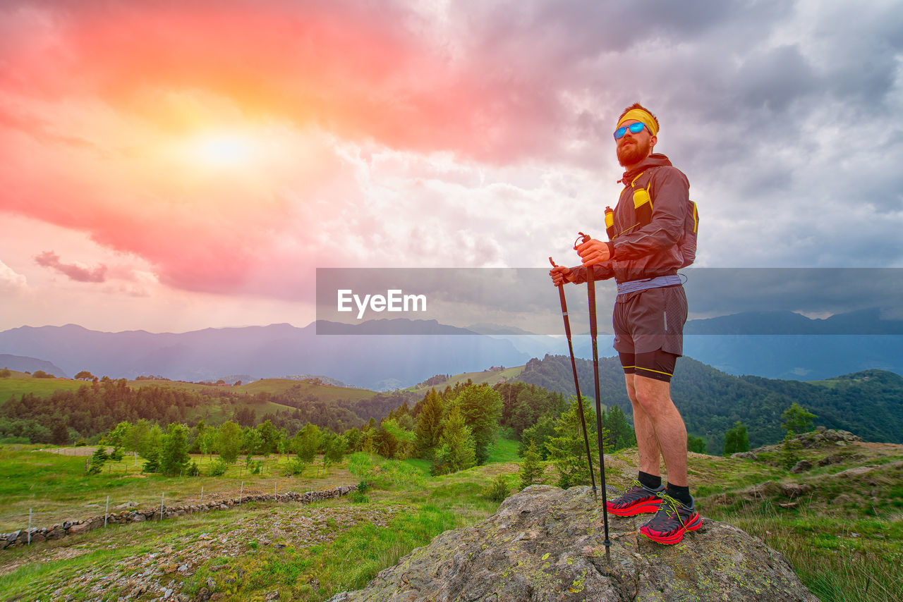 Man resting on top of the mountain during the practice of trail running in the mountain park