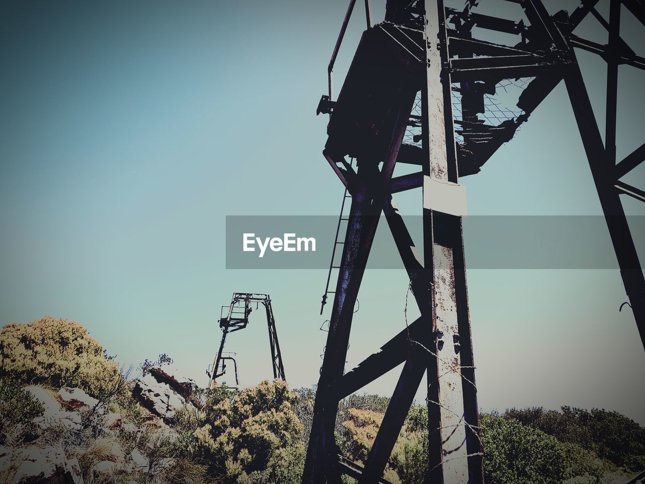 LOW ANGLE VIEW OF MACHINERY AGAINST SKY