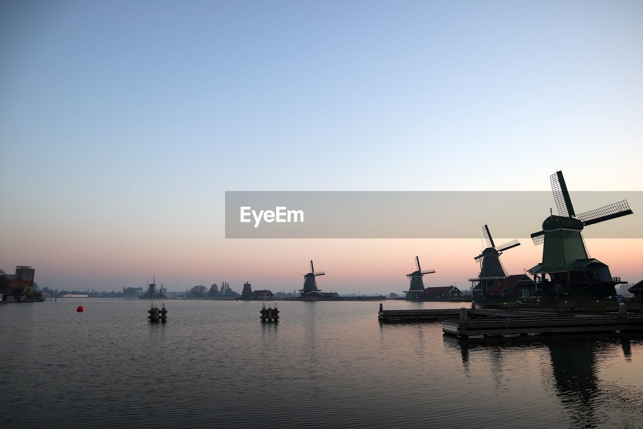 Commercial dock against clear sky during sunset