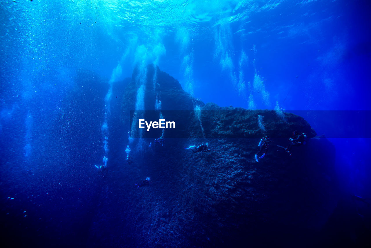 Scuba divers swimming in sea