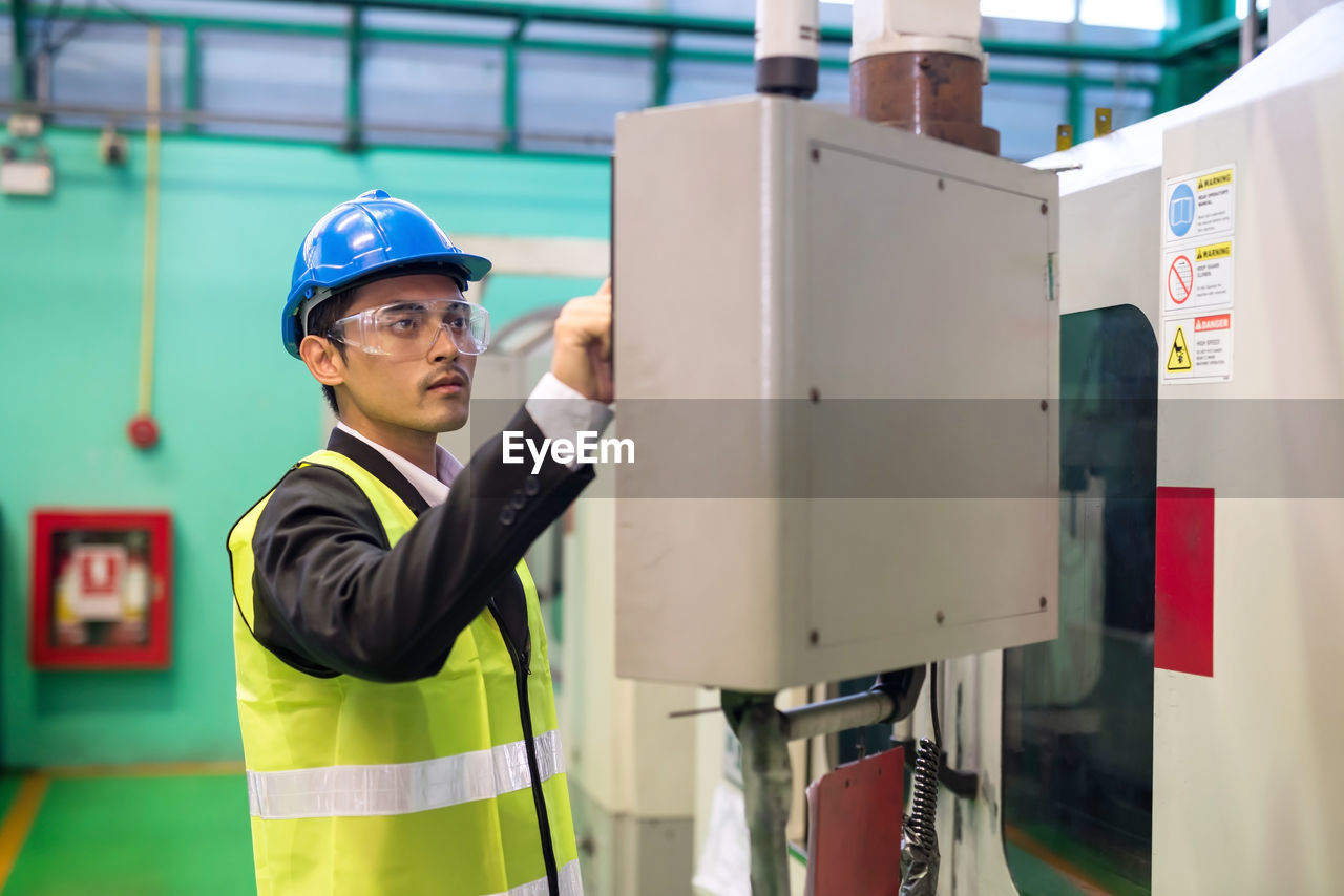 rear view of man working at factory