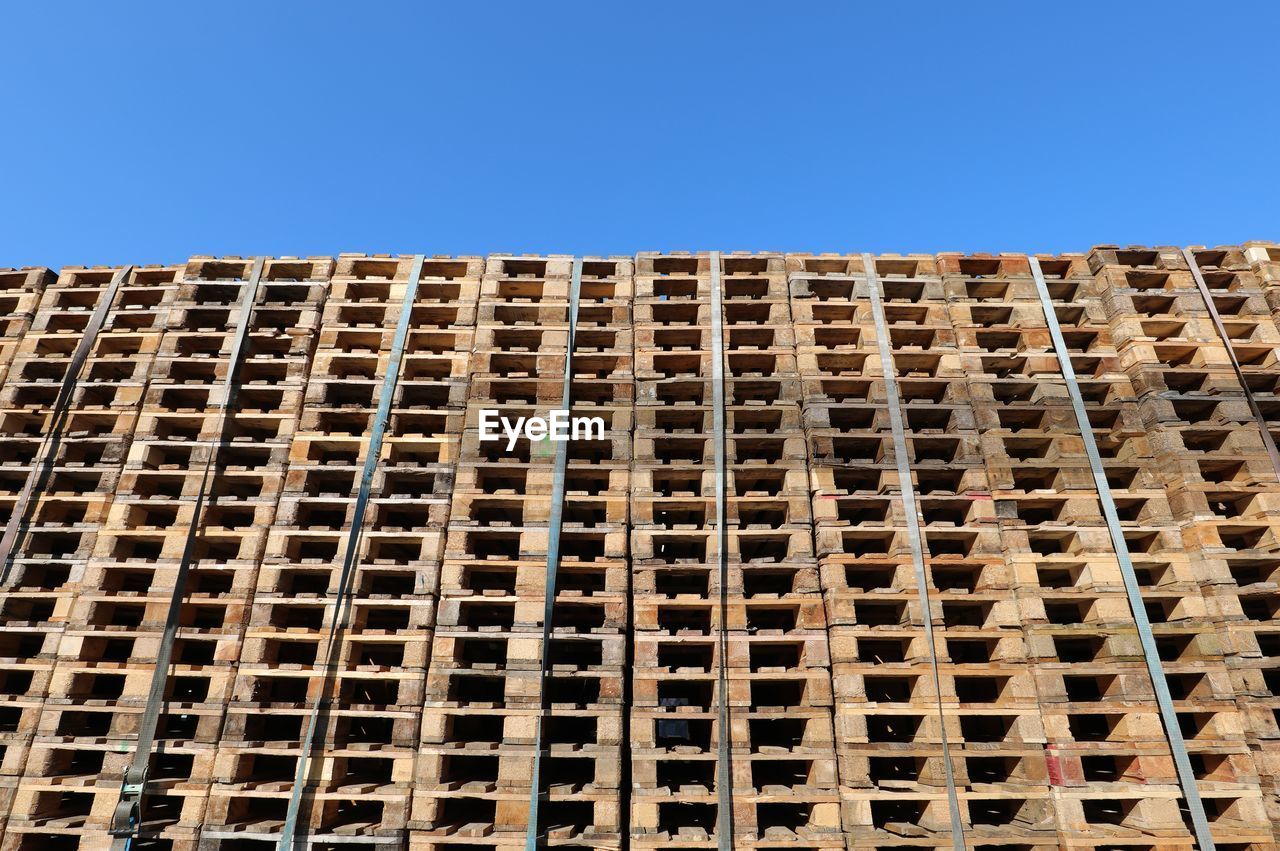 Background of many pallets and blue sky