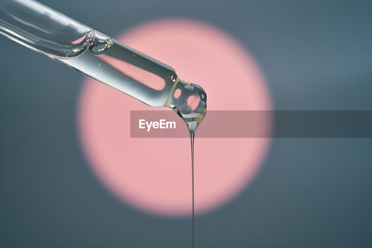 colored background, studio shot, no people, close-up, indoors, healthcare and medicine, drop