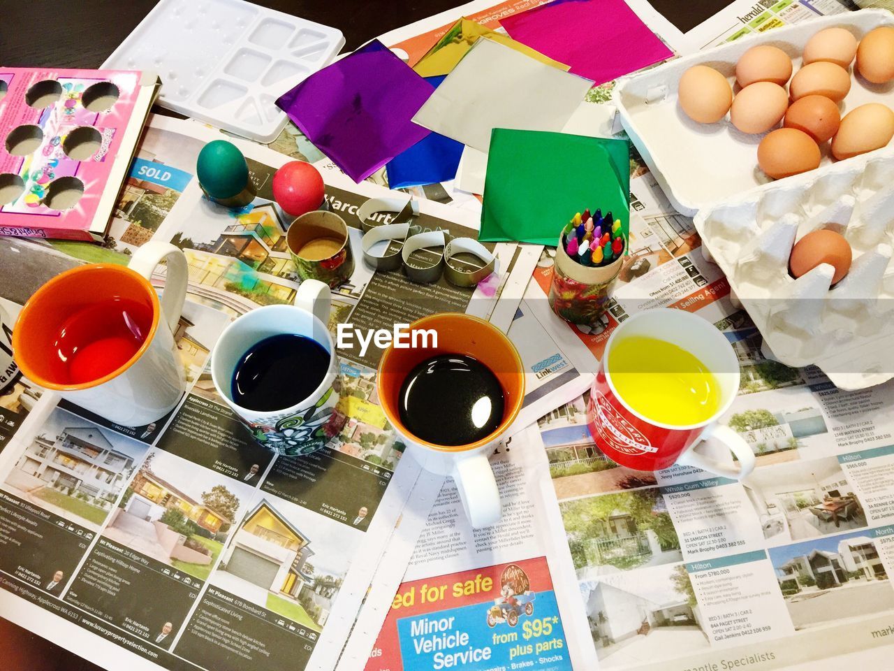 High angle view of easter eggs with craft products on table