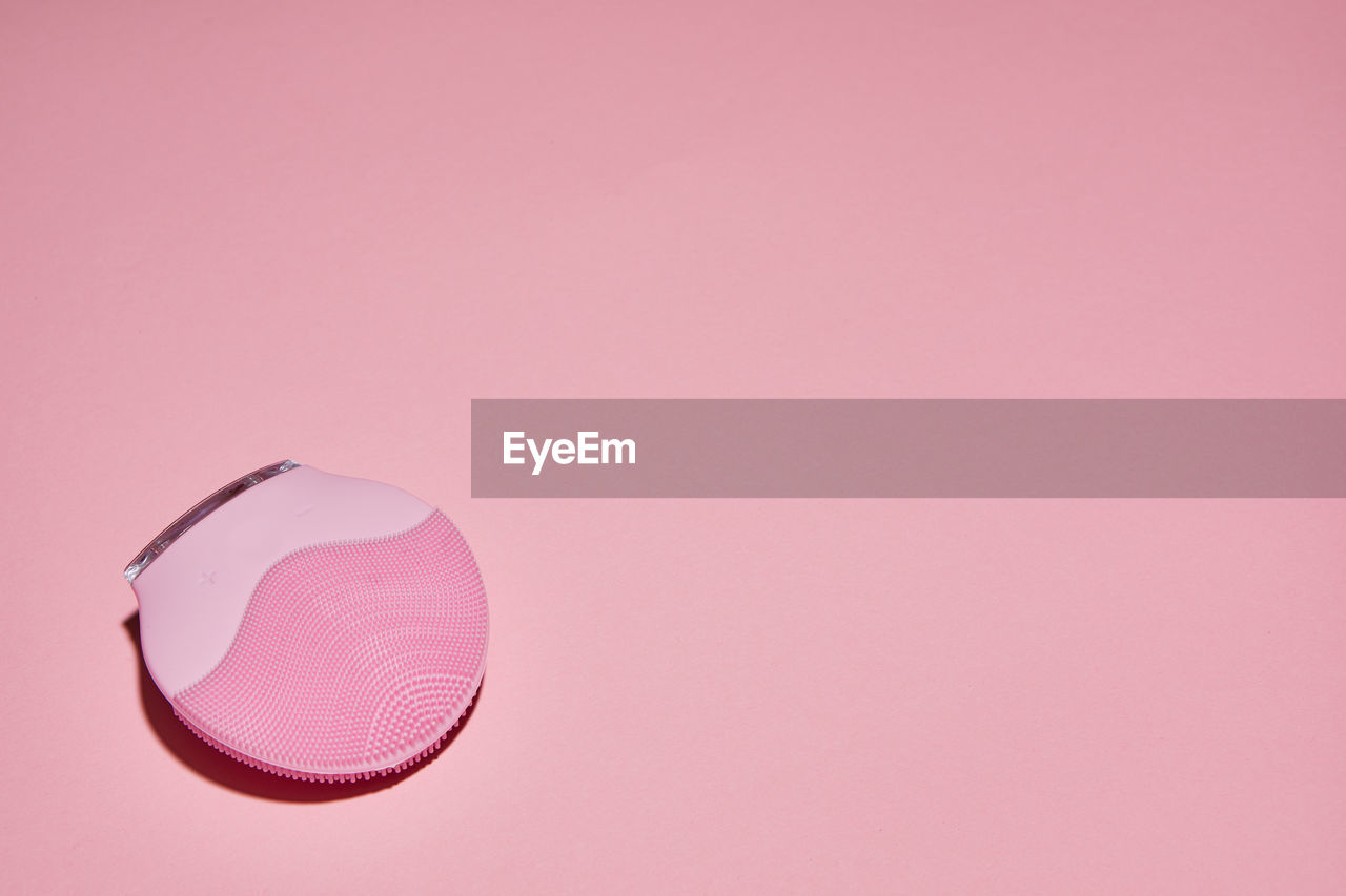 HIGH ANGLE VIEW OF PINK UMBRELLA ON GLASS