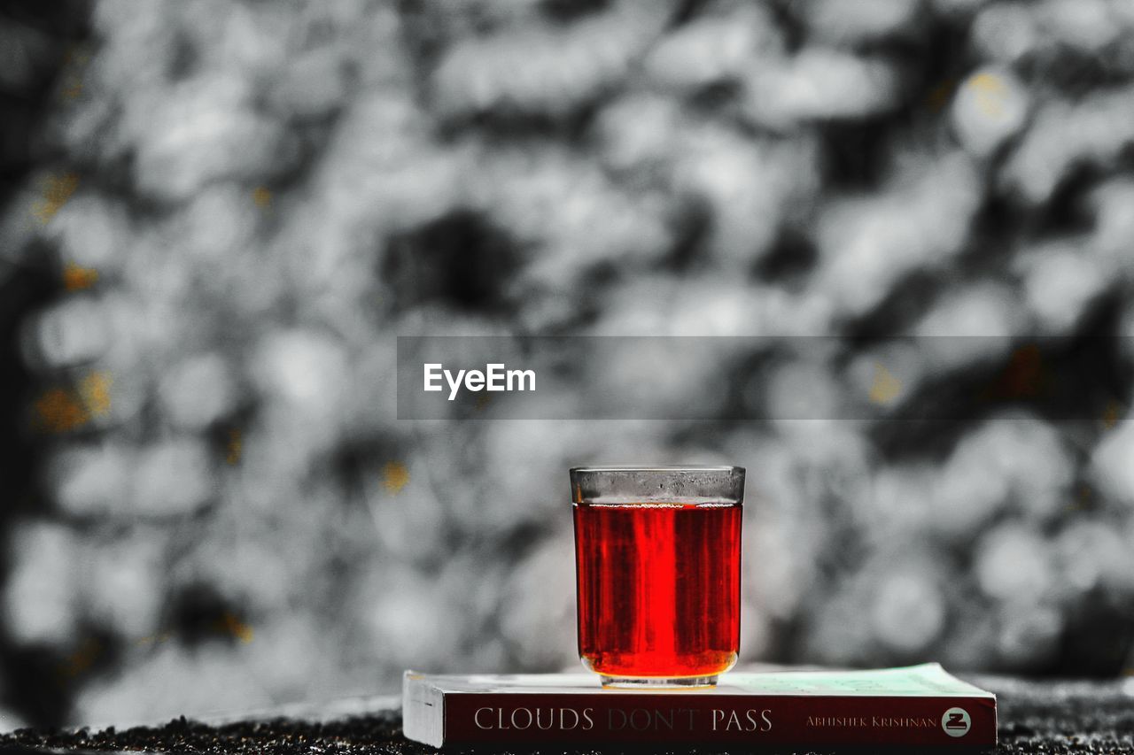 CLOSE-UP OF BEER IN GLASS ON RED