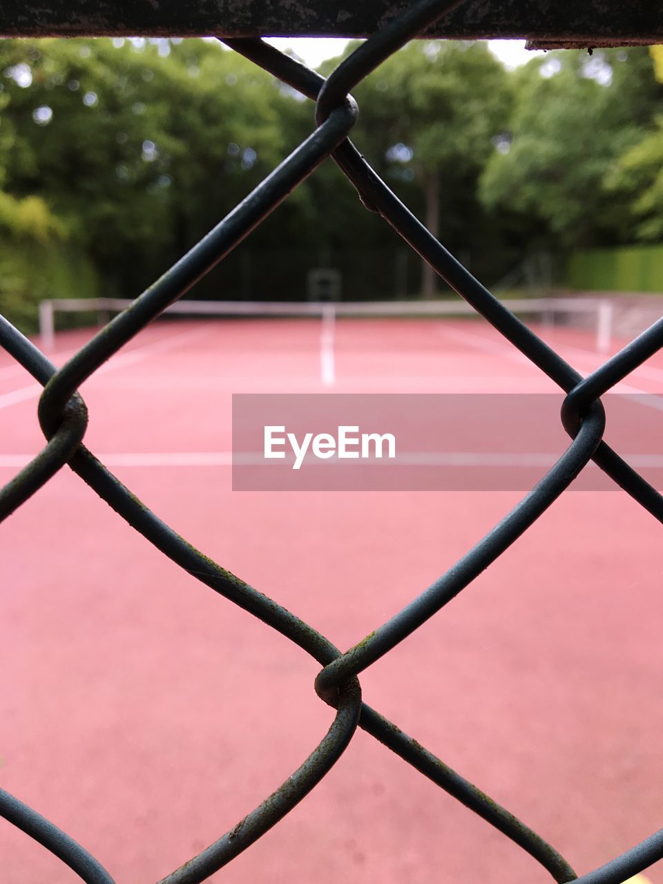 Tennis court seen through chainlink fence