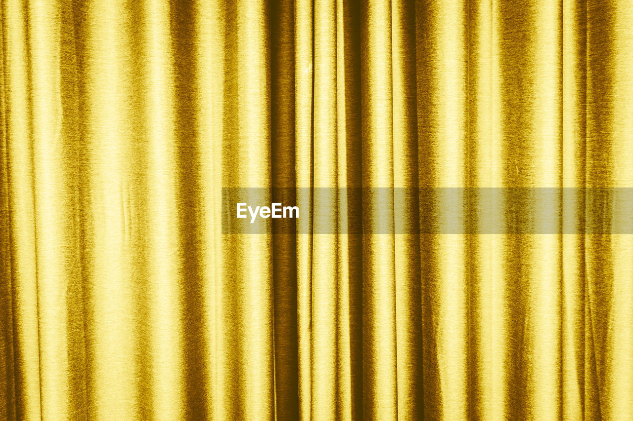 Full frame shot of gold colored curtain