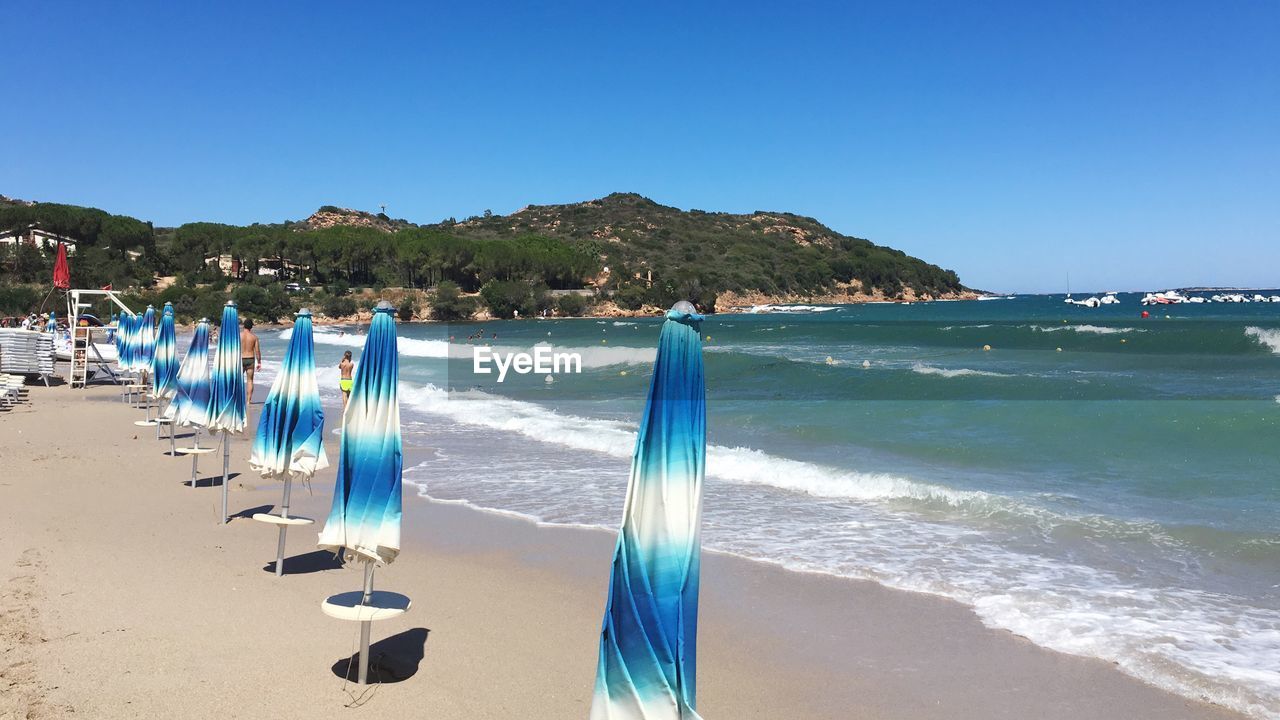 Scenic view of beach against blue sky