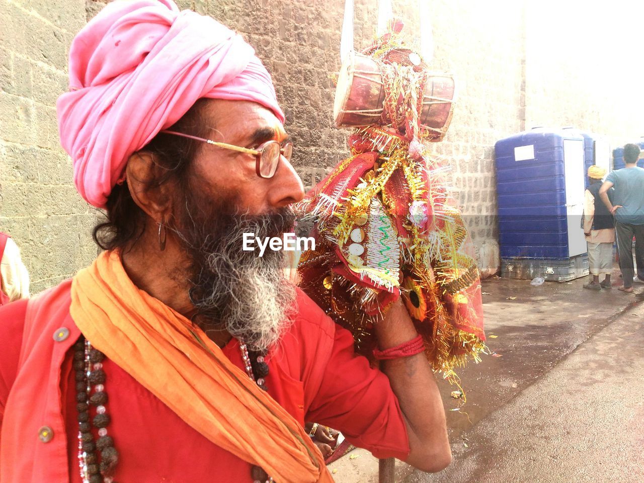 Sadhu with drum looking away