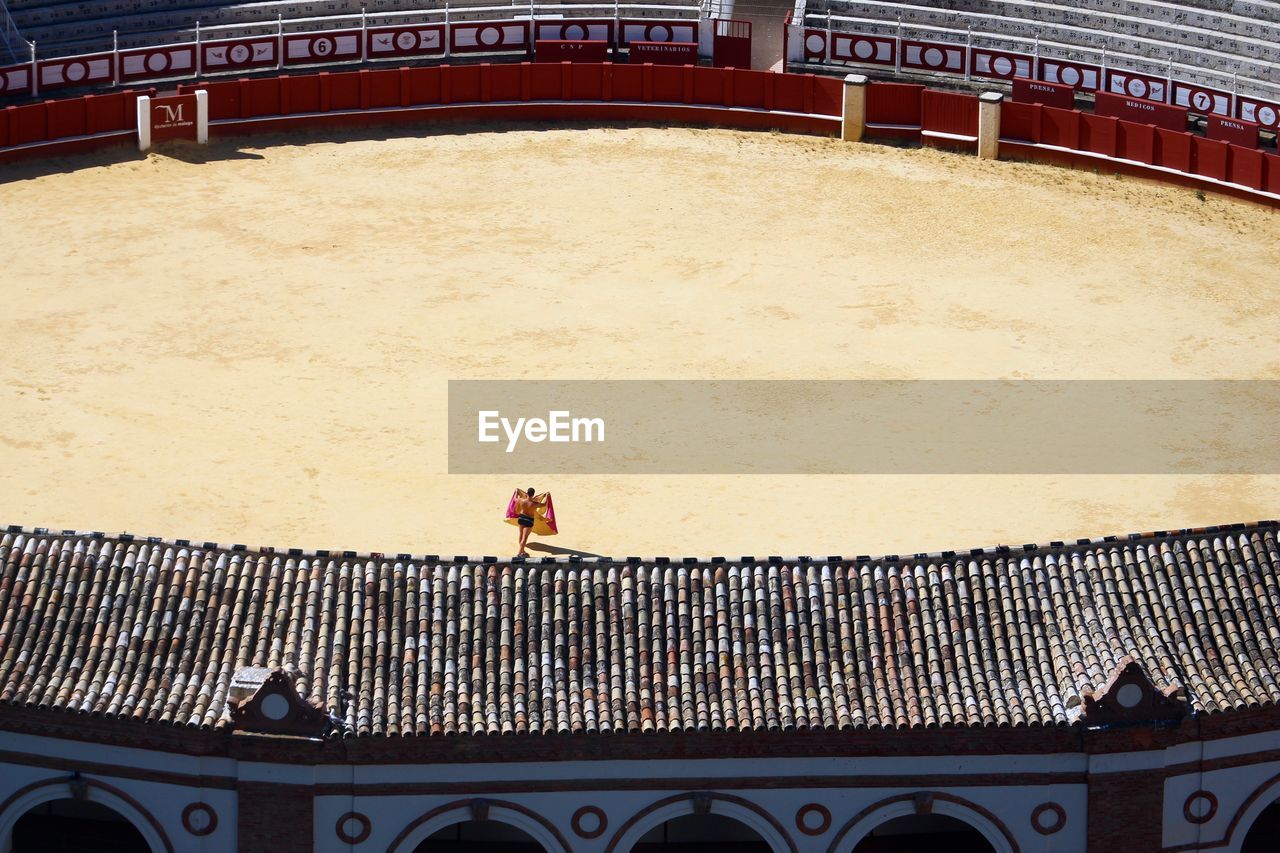 High angle view of man in bullring on sunny day