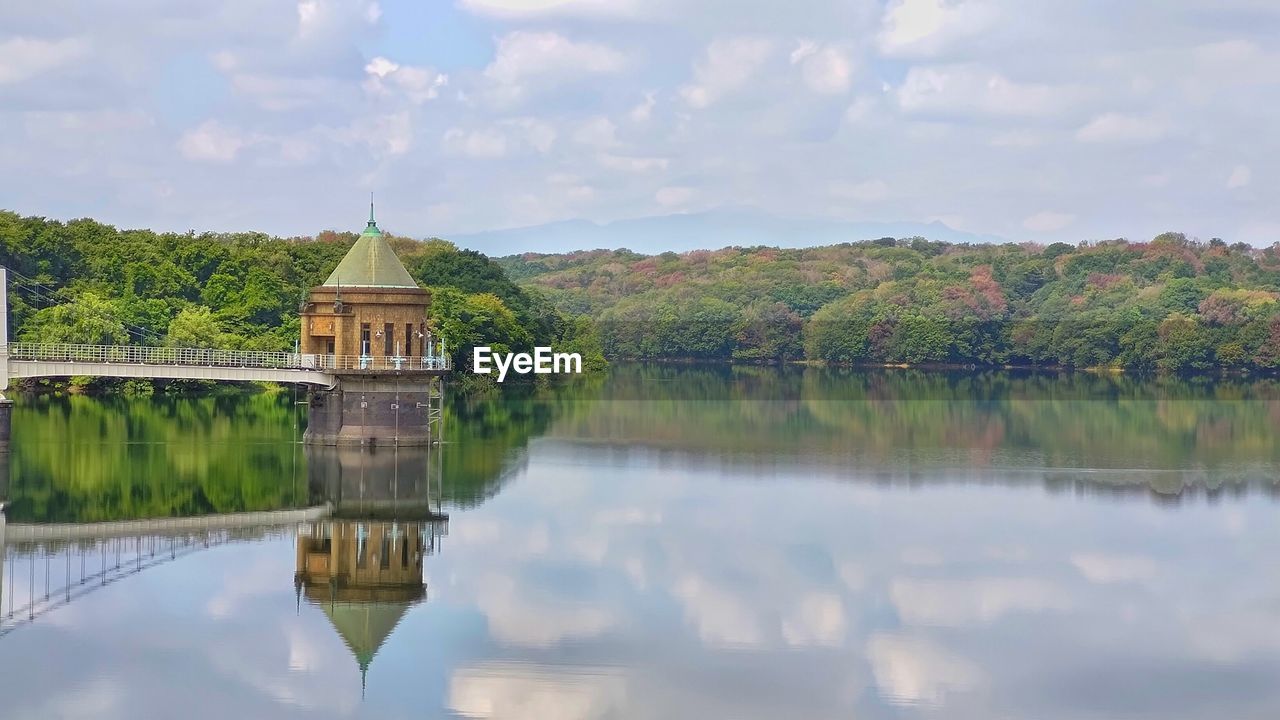 scenic view of lake by trees against sky