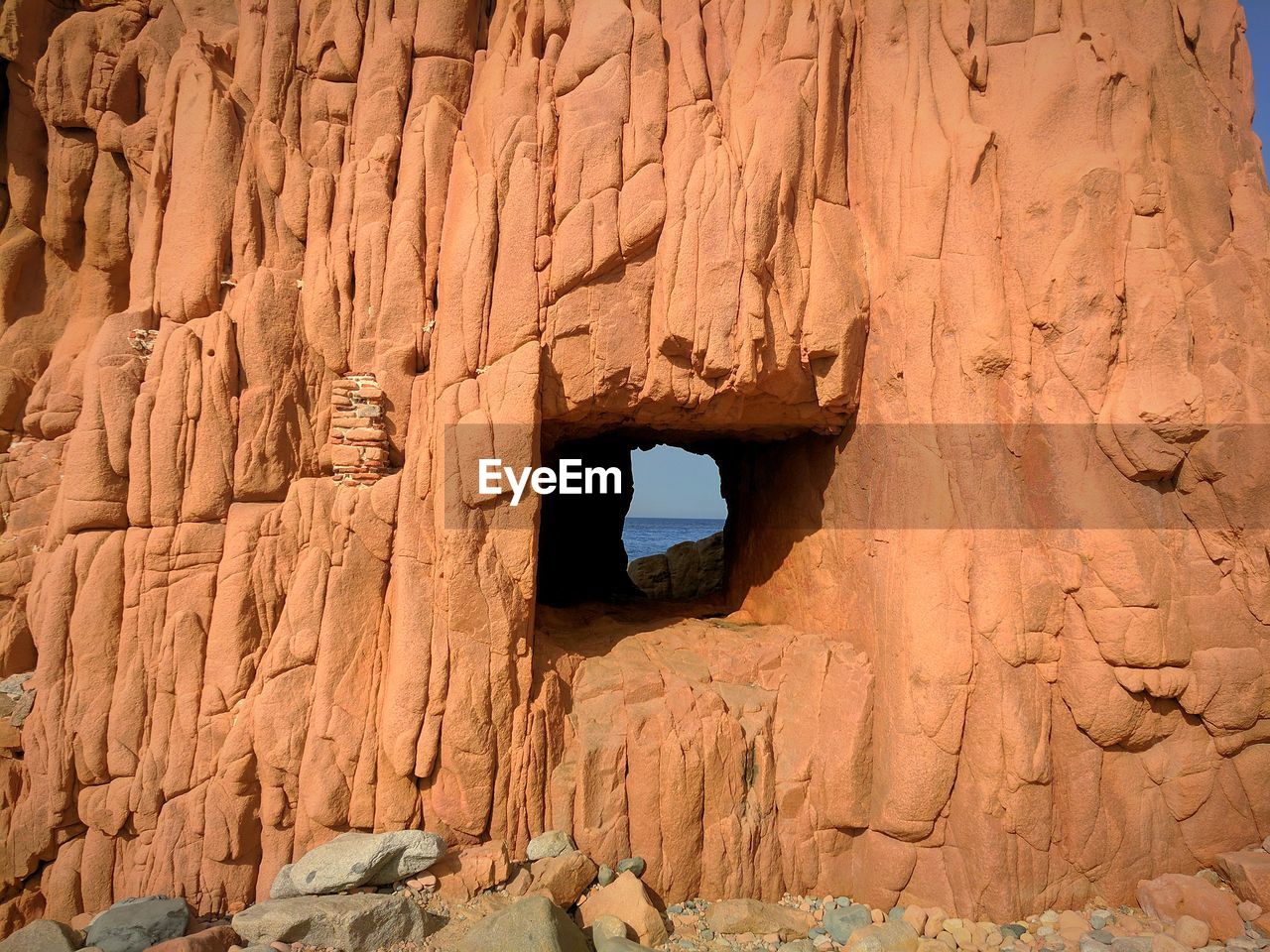 LOW ANGLE VIEW OF ROCK FORMATIONS AT CAVE