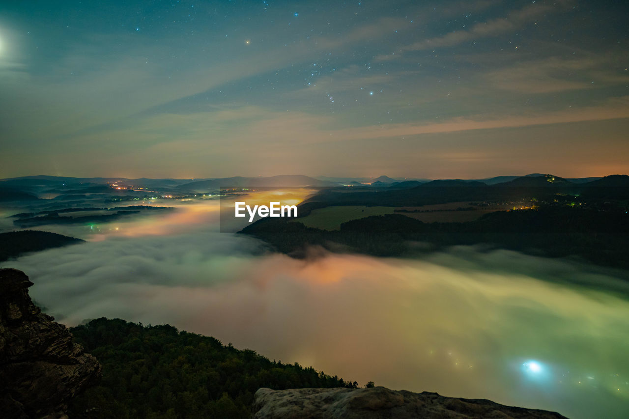 Scenic view of mountains against sky at night 