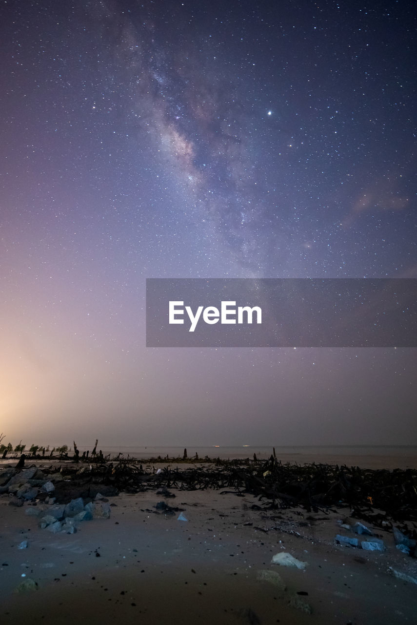 SCENIC VIEW OF SEA AGAINST STAR FIELD