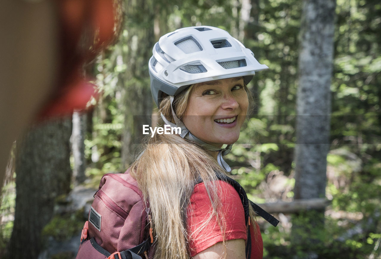 A young woman smiles during a mountain bike in oregon.
