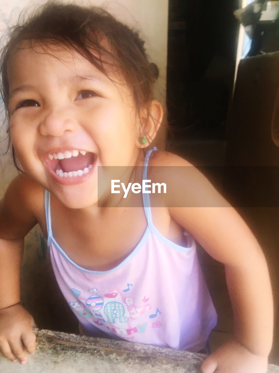 PORTRAIT OF A SMILING GIRL WITH BABY