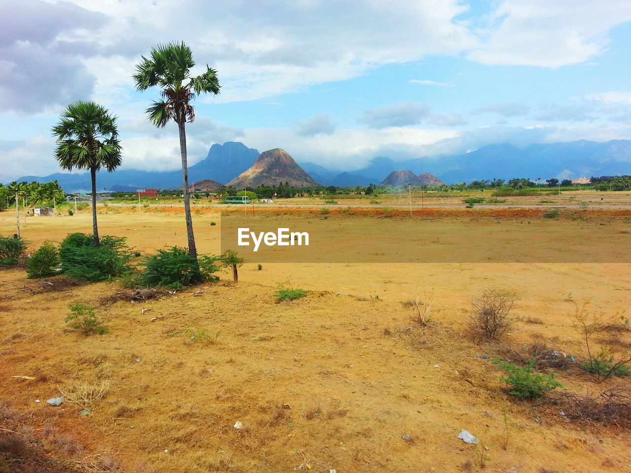 SCENIC VIEW OF BEACH BY MOUNTAINS AGAINST SKY