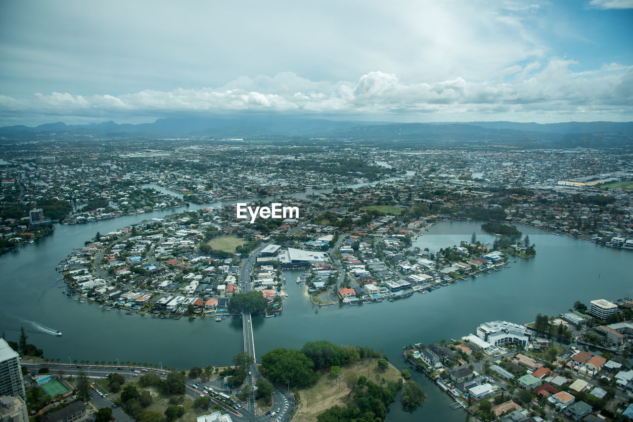 High angle view of townscape by sea against sky