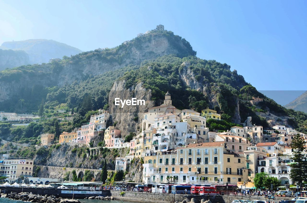 High angle view of townscape by mountain against sky