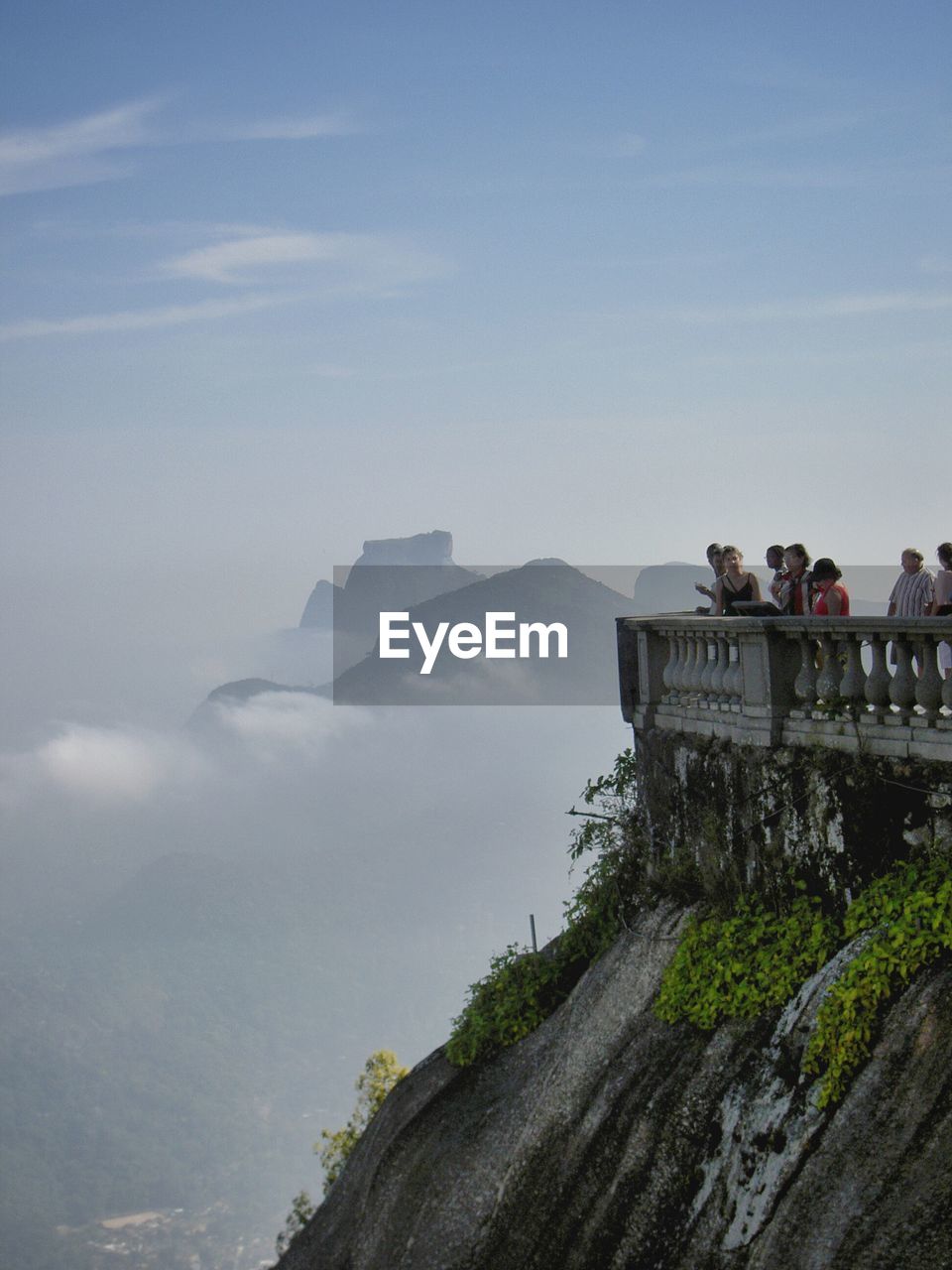 People enjoying view of mountains from observation point