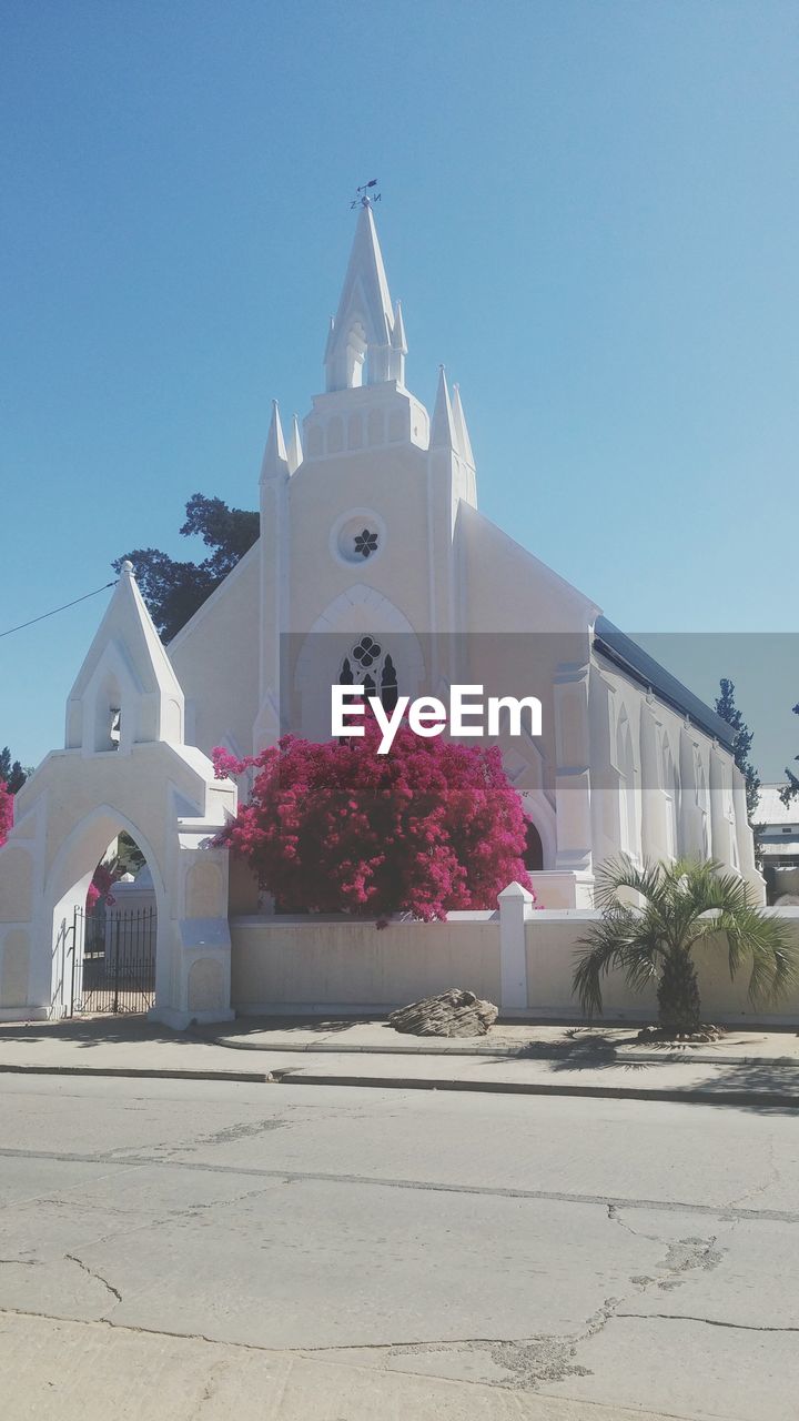 Exterior of church against clear blue sky