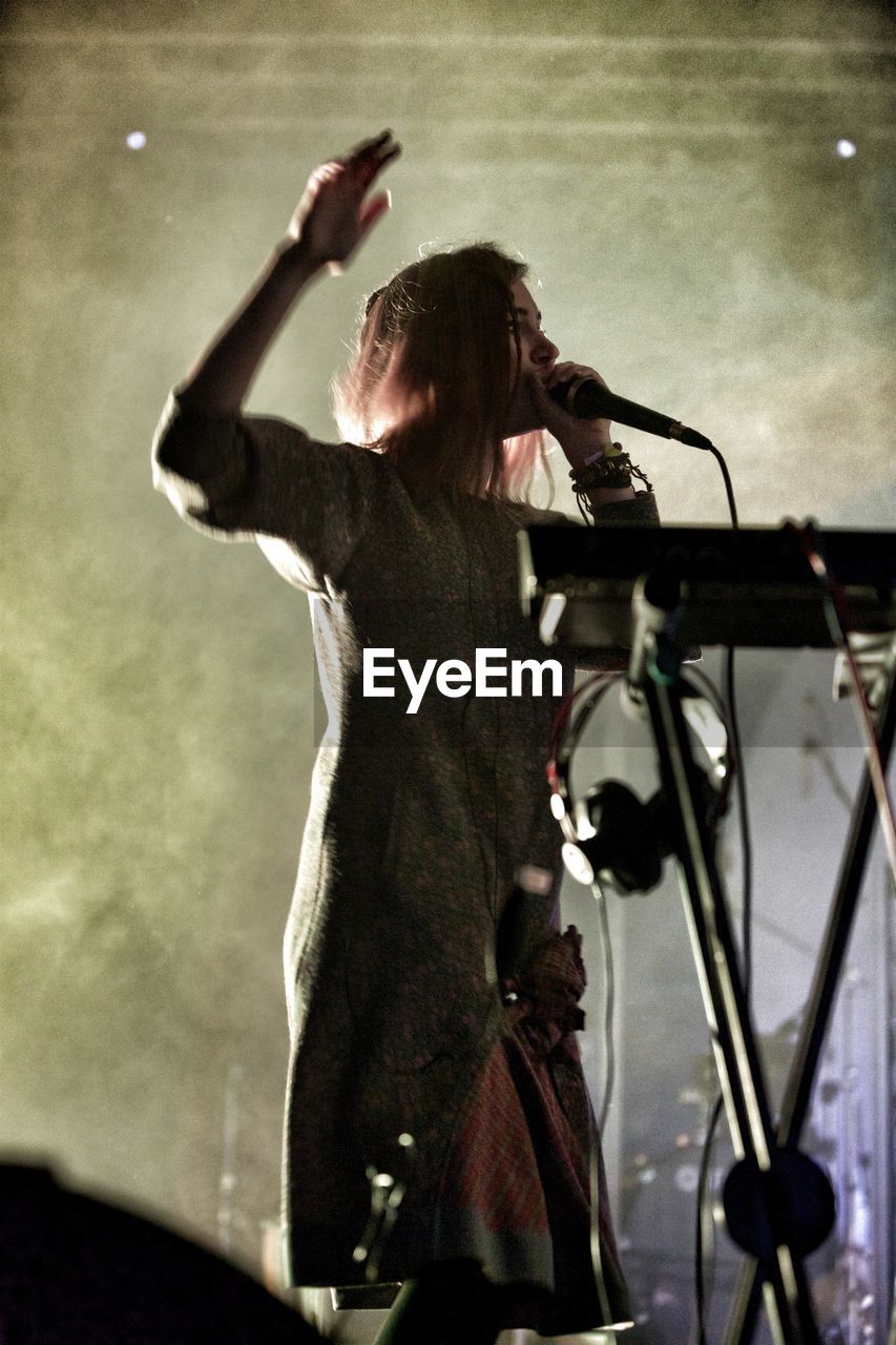 Low angle of a woman singer on stage