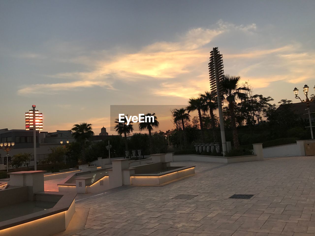 SWIMMING POOL AGAINST SKY AT SUNSET