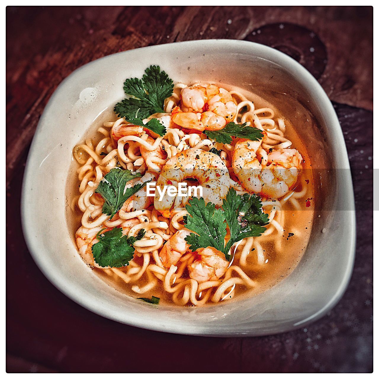 High angle view of soup noodle with prawns served in bowl