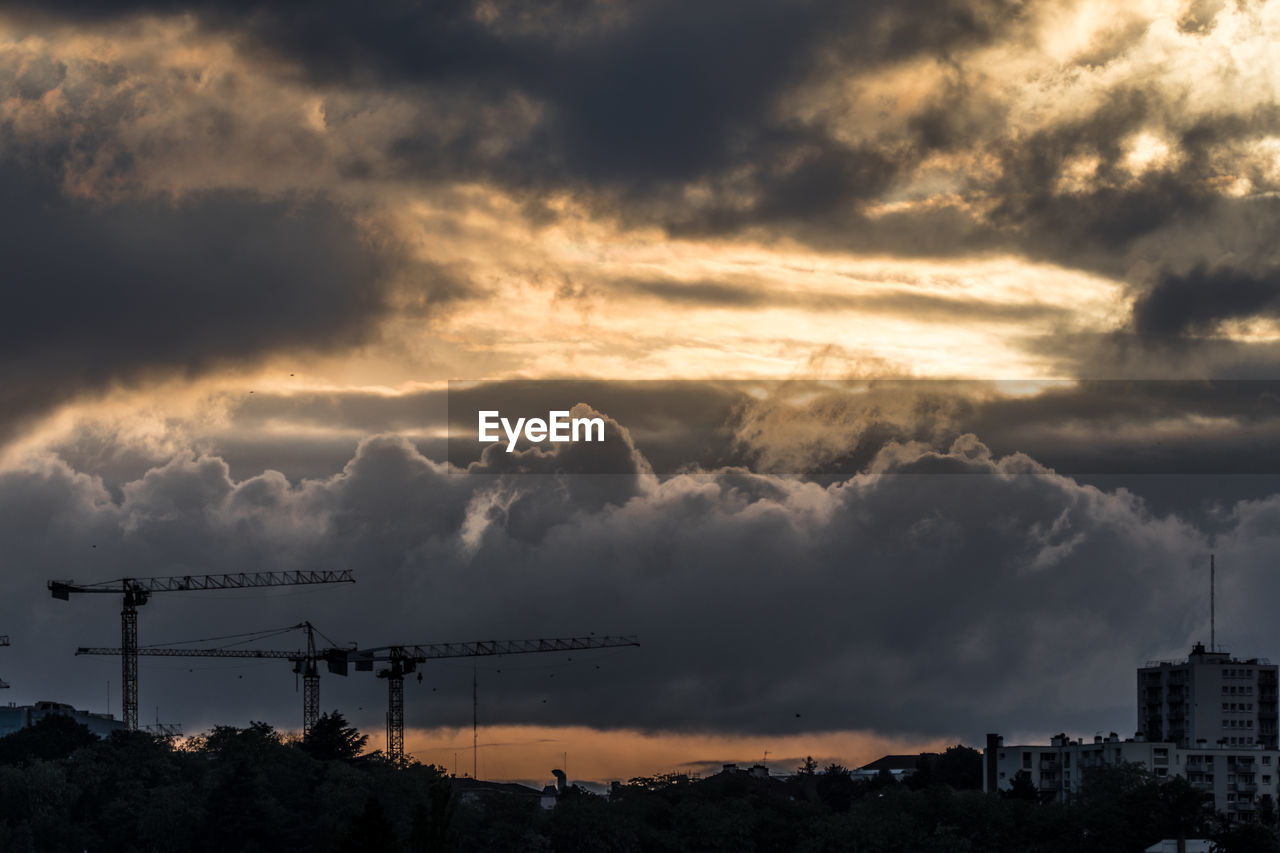 SILHOUETTE CITYSCAPE AGAINST DRAMATIC SKY