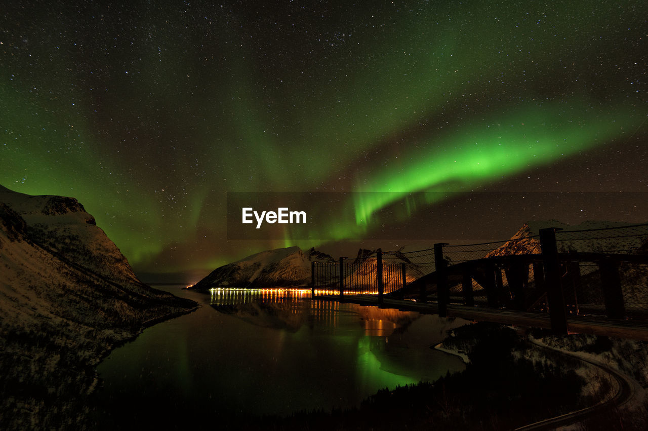 Scenic view of lake against sky at night