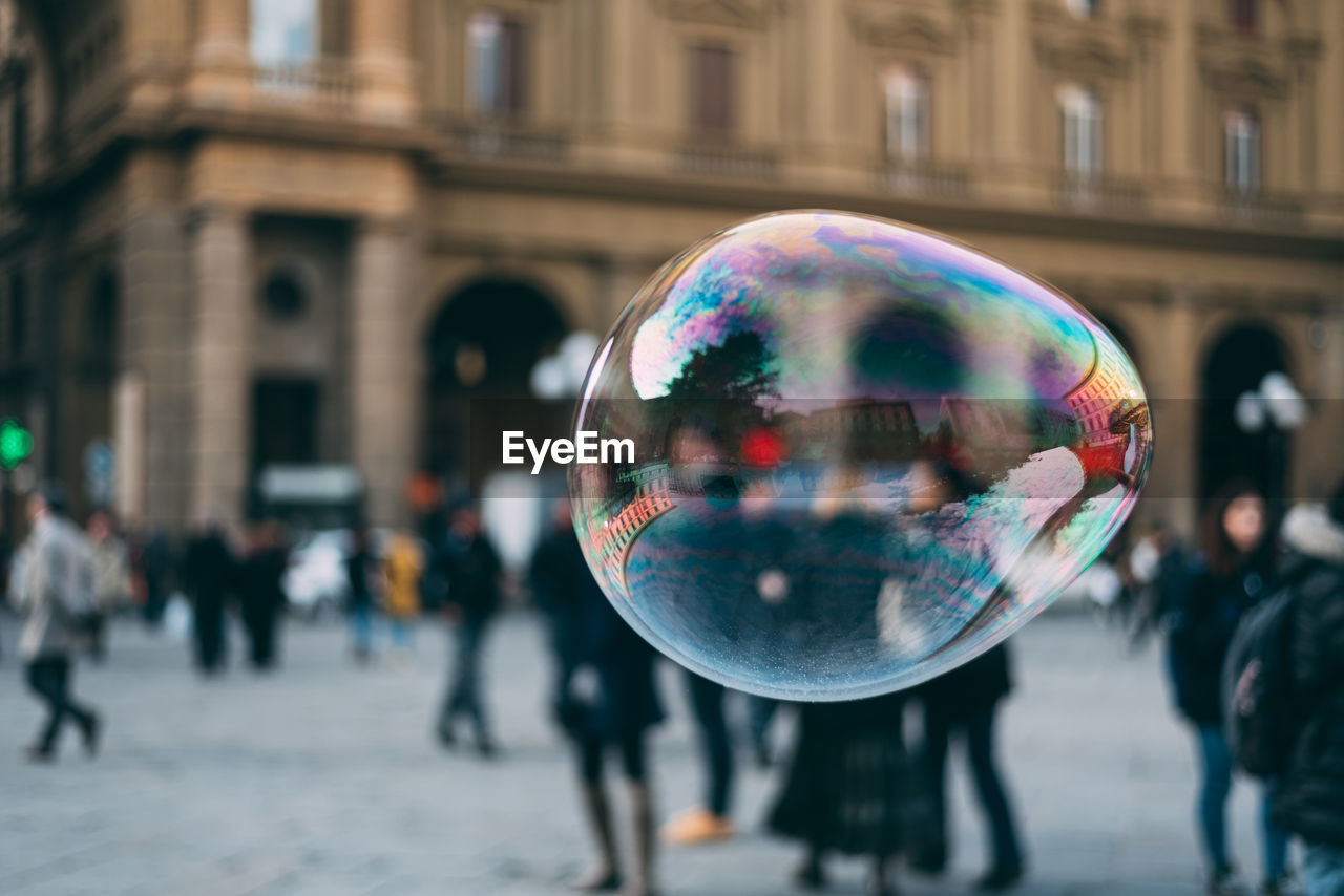 Close-up of bubble flying on street in city