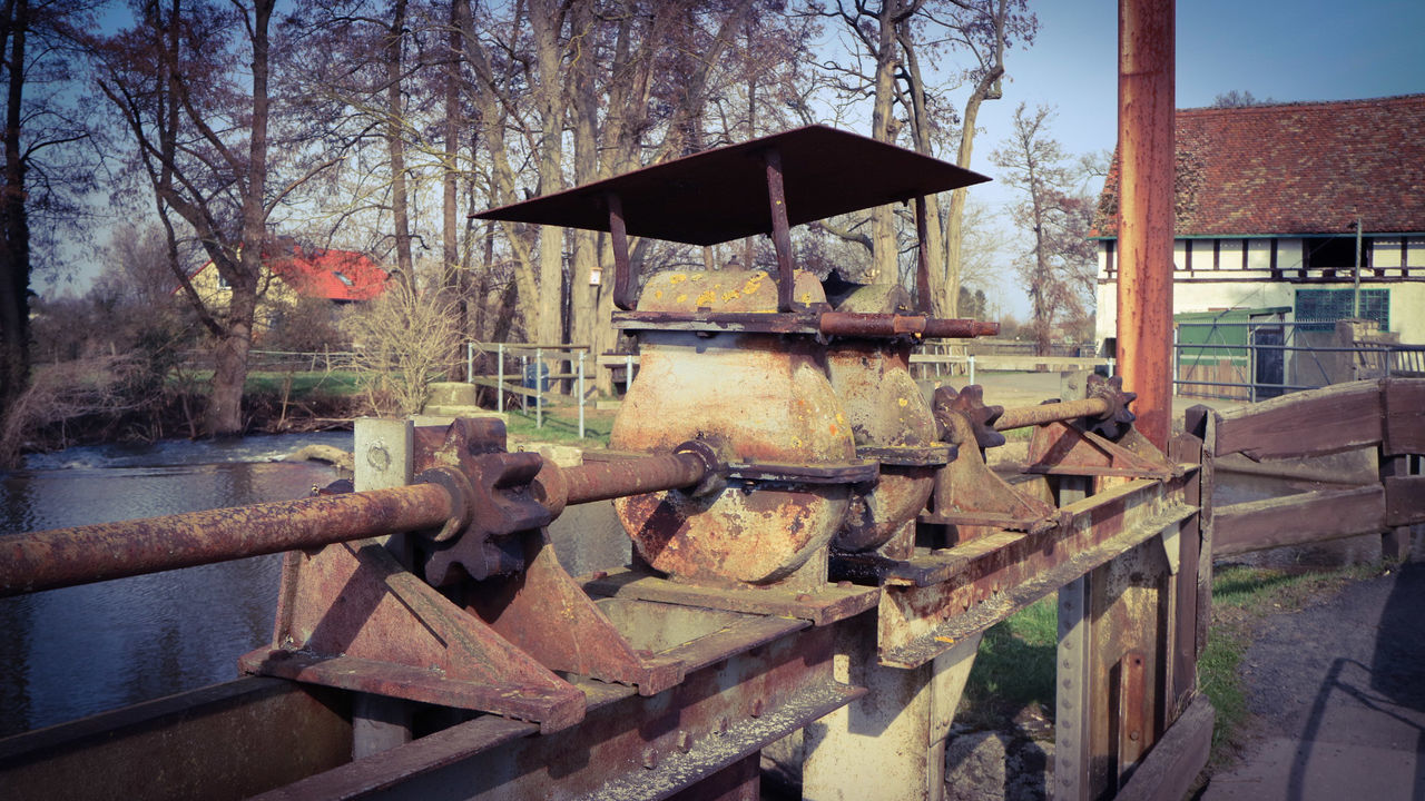 Rusty machinery by river