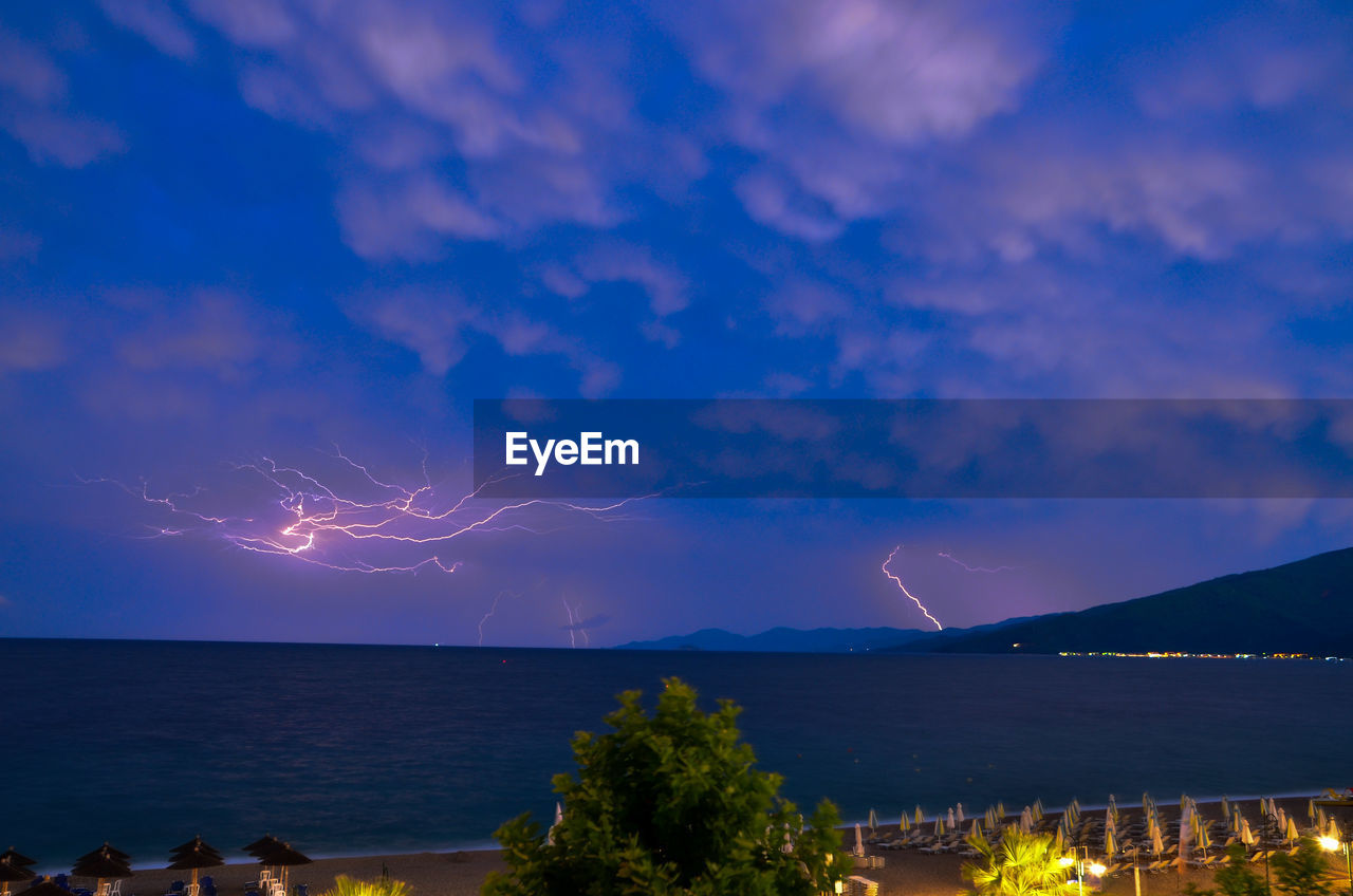 Scenic view of sea against sky at night