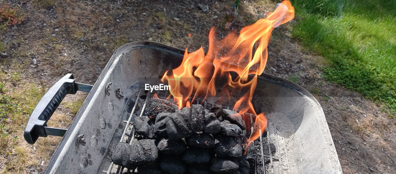 HIGH ANGLE VIEW OF BONFIRE ON BARBECUE