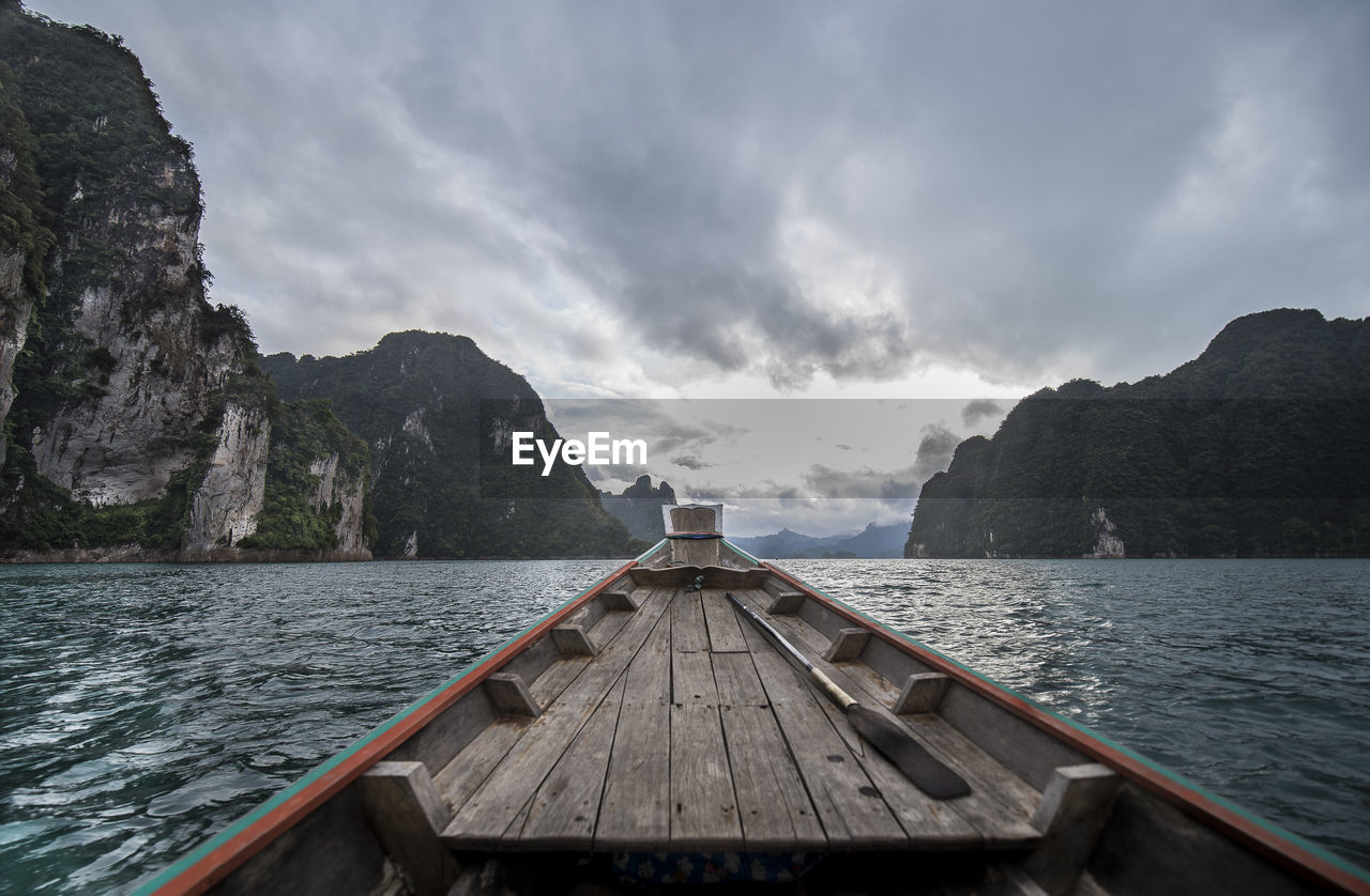 Scenic view of sea and mountains against sky