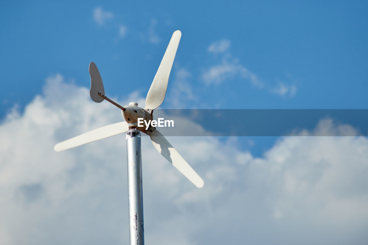 Low angle view of wind turbine against sky