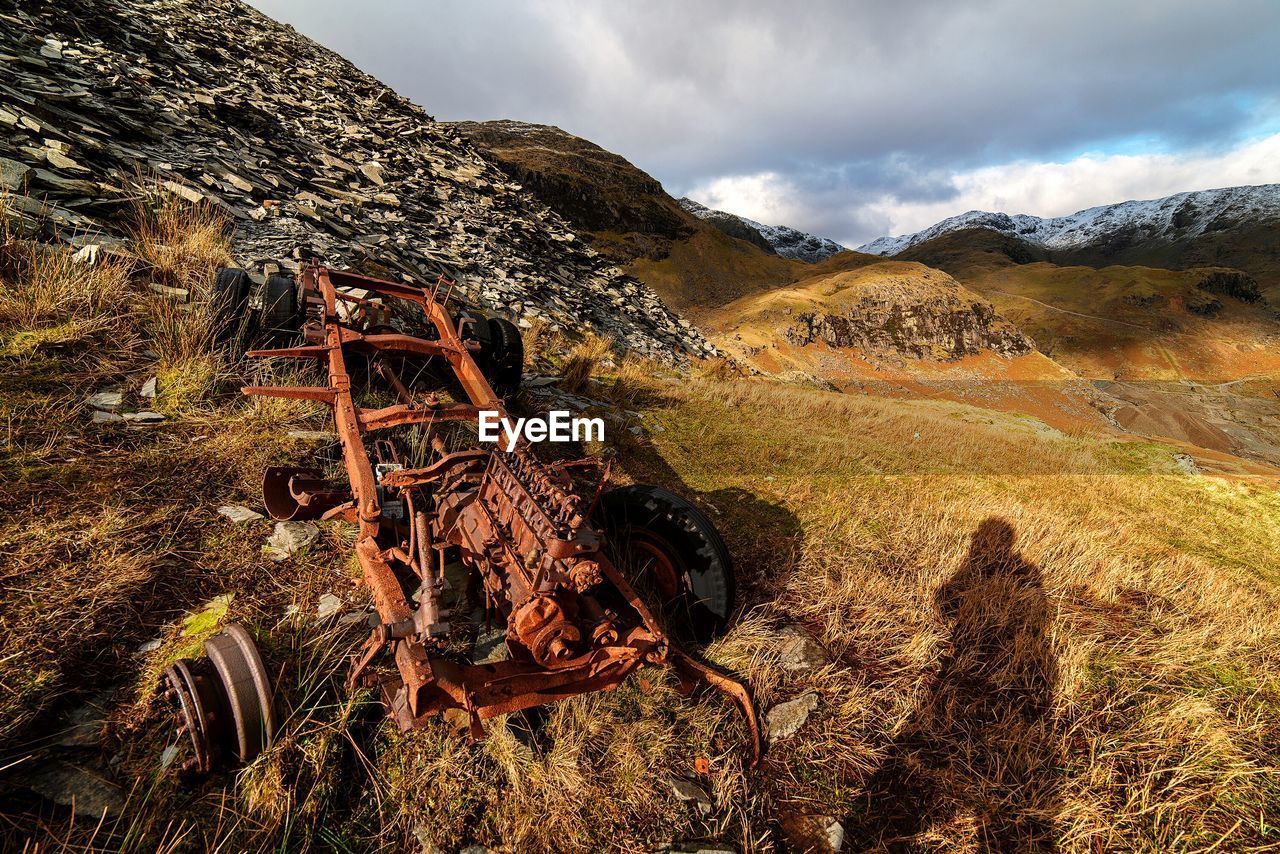 Abandoned vehicle on countryside landscape