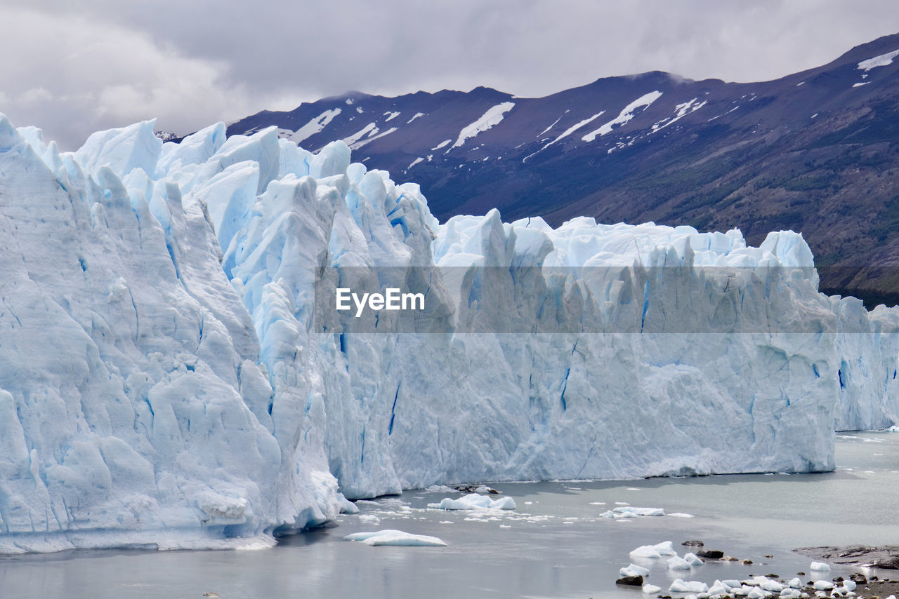 Scenic view of sea and glacier against sky