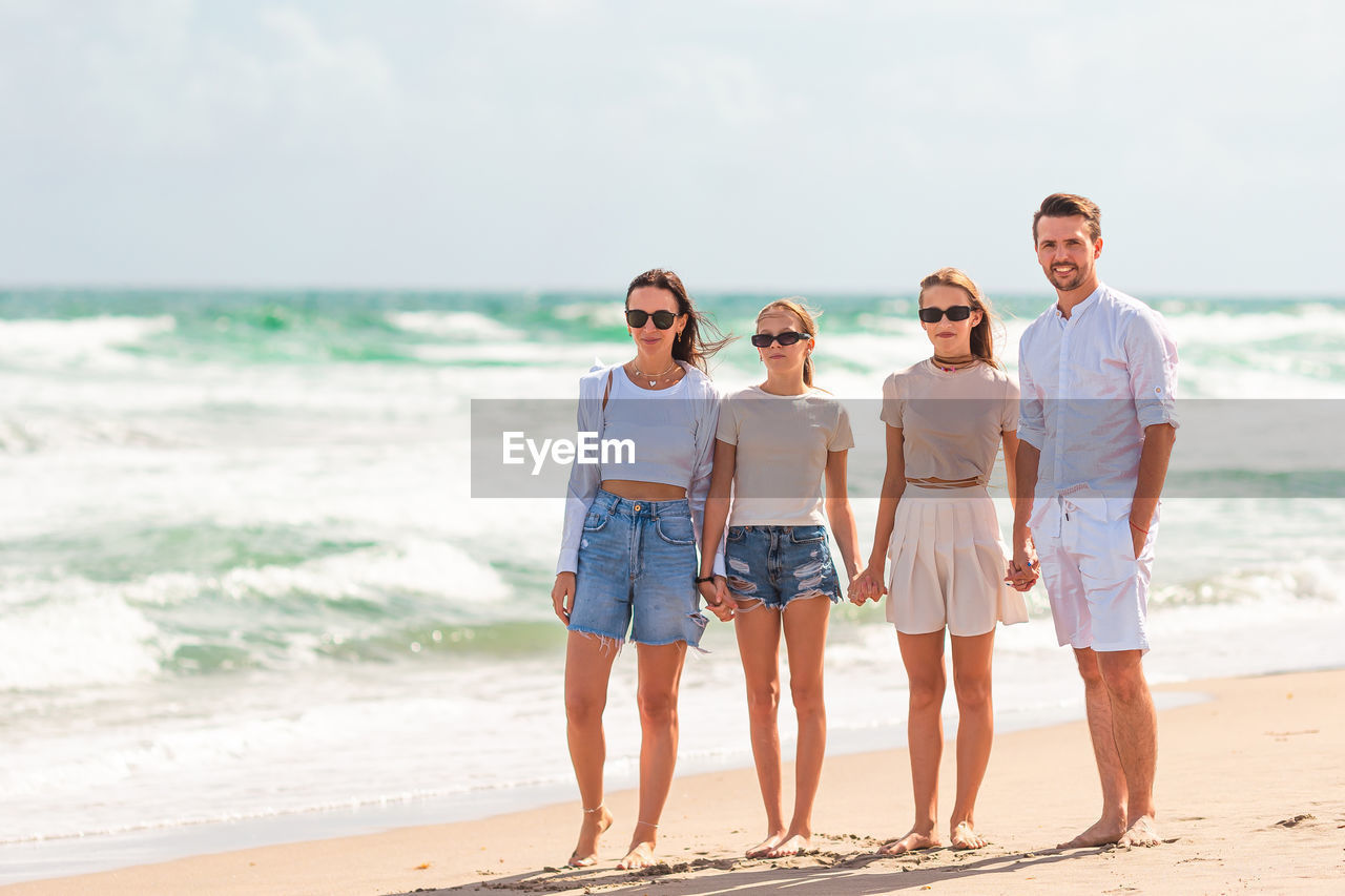 rear view of couple standing at beach